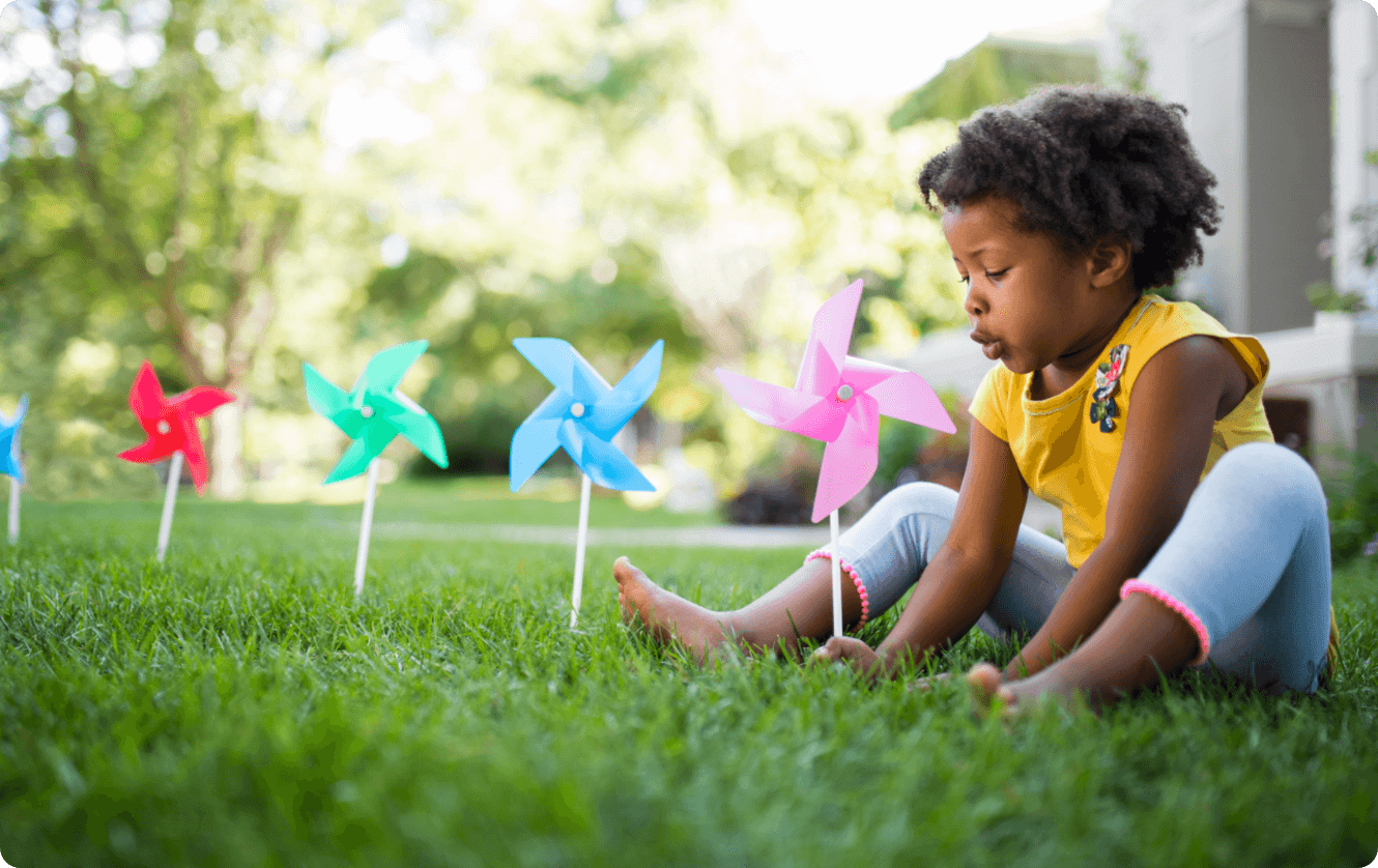 small child sitting on grass